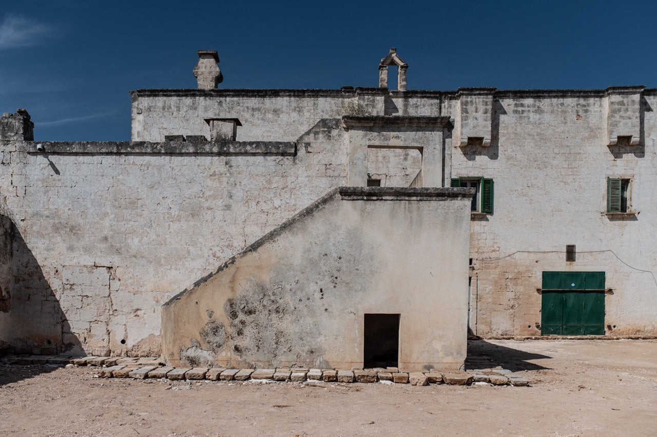 Masseria Carrassa building facade before restoration with weathered stone
