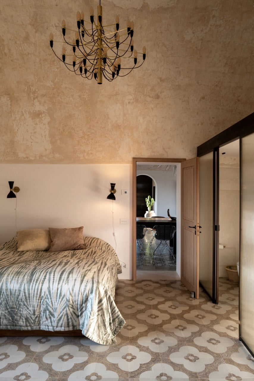 Bedroom with chandelier and view through to dining room