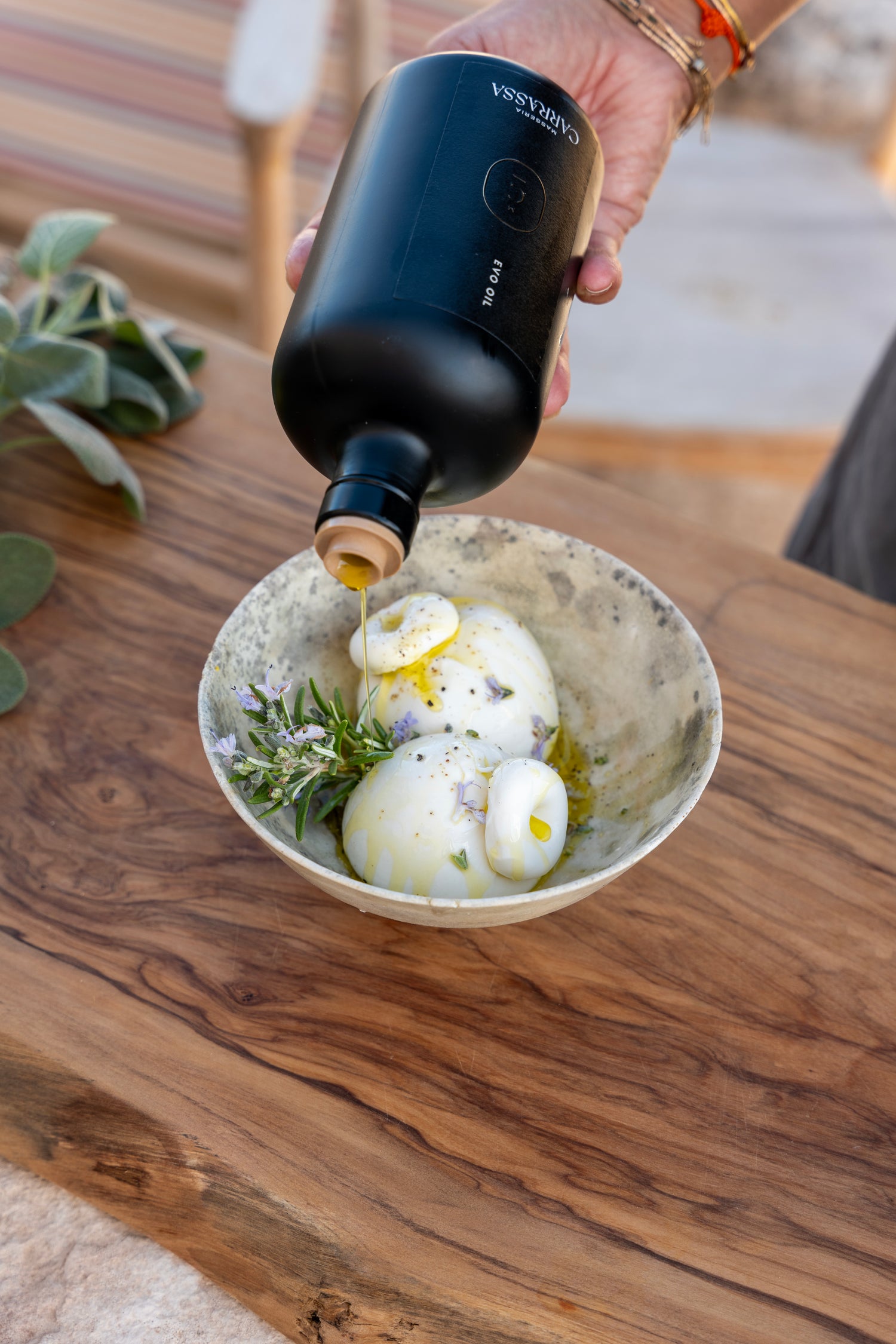 Masseria Carrassa olive oil drizzled over burrata with rosemary