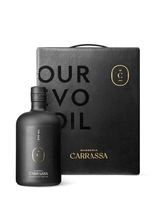Masseria Carrassa olive oil bottle beside matching black gift box