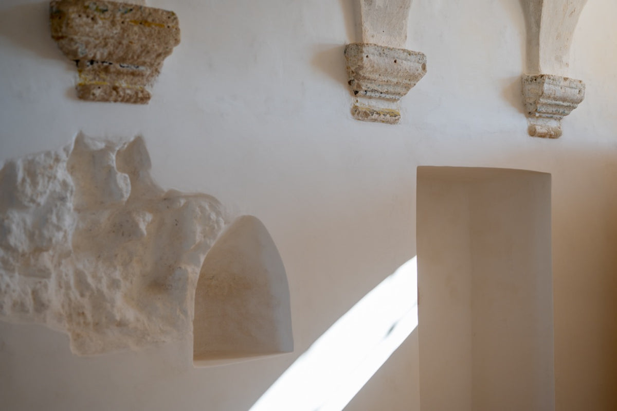 Restored kitchen wall with stone corbels and carved alcove