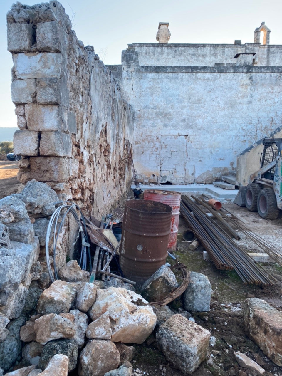 Ruins of a stone building with construction materials