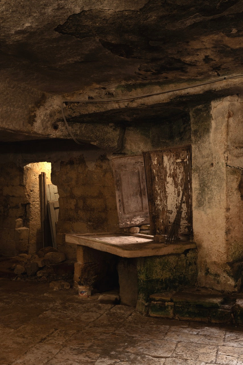 Stone table and workbench inside an ancient carved grotto room